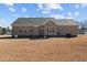 The back exterior features a neutral siding and a well-maintained yard at 121 Starlight Dr, Lillington, NC 27546