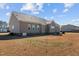Back of the house with a view of the lawn at 121 Starlight Dr, Lillington, NC 27546