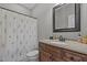 Bathroom with wood vanity, shower curtain, and neutral color palette at 121 Starlight Dr, Lillington, NC 27546