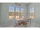 Bright dining area featuring 'let's eat' decor and natural light from three windows at 121 Starlight Dr, Lillington, NC 27546