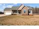 Charming home with a manicured lawn, complemented by a two-car garage and quaint window shutters at 121 Starlight Dr, Lillington, NC 27546