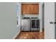 Laundry room with window, updated cabinets, and stainless washer and dryer at 121 Starlight Dr, Lillington, NC 27546