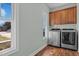 A bright laundry room with large window and updated stainless steel washer and dryer at 121 Starlight Dr, Lillington, NC 27546