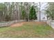 Large fenced backyard with mature trees and ample green space at 1233 Dunn Creek Xing, Wake Forest, NC 27587
