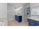 Bright bathroom with a deep blue vanity, double sinks, and modern fixtures at 1233 Dunn Creek Xing, Wake Forest, NC 27587
