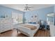 Bright bedroom with a bed, dresser, wood floors and light blue walls at 1233 Dunn Creek Xing, Wake Forest, NC 27587
