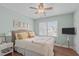 Cozy bedroom with a queen-sized bed, wood floors, and a ceiling fan at 1233 Dunn Creek Xing, Wake Forest, NC 27587