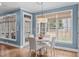 Bright breakfast nook with a round table set next to large windows and hardwood floors at 1233 Dunn Creek Xing, Wake Forest, NC 27587