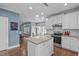 Open kitchen with white cabinetry, stainless appliances, and a central island overlooking the breakfast nook at 1233 Dunn Creek Xing, Wake Forest, NC 27587