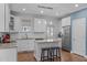 Spacious white kitchen features granite countertops, an island with seating, and stainless steel appliances at 1233 Dunn Creek Xing, Wake Forest, NC 27587