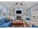 Inviting living room featuring a fireplace, built-in shelving, and hardwood floors, creating a warm and inviting atmosphere at 1233 Dunn Creek Xing, Wake Forest, NC 27587
