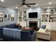 Comfortable living room featuring a fireplace, built-in shelving, and hardwood floors, creating a warm and inviting atmosphere at 1233 Dunn Creek Xing, Wake Forest, NC 27587