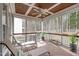 Screened porch featuring ceiling fan, wooded views and comfortable lounge furniture at 1233 Dunn Creek Xing, Wake Forest, NC 27587