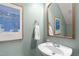 Quaint powder room featuring charming artwork, a stylish mirror, and a neatly arranged towel at 1233 Dunn Creek Xing, Wake Forest, NC 27587