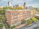 Aerial view of a condo building with balconies and brick facade in an urban setting at 200 S Dawson St # 303, Raleigh, NC 27601