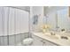 Bright bathroom with a toilet, a shower with a white curtain, and a sink with a mirror at 200 S Dawson St # 303, Raleigh, NC 27601