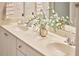 Bathroom with double sinks, floral accents, and white countertops at 200 S Dawson St # 303, Raleigh, NC 27601