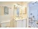 Bright bathroom featuring a modern vanity with a sink, decorative mirror, and stylish lighting fixture at 200 S Dawson St # 303, Raleigh, NC 27601