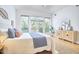 Bedroom featuring wood floors, area rug, a dresser, and access to balcony at 200 S Dawson St # 303, Raleigh, NC 27601