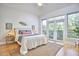 Bright bedroom featuring a neutral color palette, balcony access, and natural light at 200 S Dawson St # 303, Raleigh, NC 27601