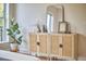 Bedroom dresser featuring greenery and modern mirror at 200 S Dawson St # 303, Raleigh, NC 27601