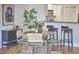 Cozy dining area with a round table, comfortable chairs, and modern decor adjacent to a kitchen with bar seating at 200 S Dawson St # 303, Raleigh, NC 27601