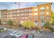 Brick condo building with arched windows, balconies, and parking at Park Devereux at 200 S Dawson St # 303, Raleigh, NC 27601