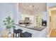 Bright kitchen features a breakfast bar with black granite countertops and white cabinets at 200 S Dawson St # 303, Raleigh, NC 27601