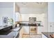 Well-lit kitchen with white cabinets, stainless steel appliances, and a black granite countertop at 200 S Dawson St # 303, Raleigh, NC 27601