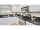 Kitchen featuring stainless steel appliances, black countertops, and white cabinets at 200 S Dawson St # 303, Raleigh, NC 27601
