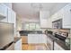 Kitchen showcases white cabinets, stainless steel appliances, and black countertops at 200 S Dawson St # 303, Raleigh, NC 27601