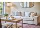 Comfortable sofa with throw pillows in a sunlit living room, complete with wooden coffee table and decor at 200 S Dawson St # 303, Raleigh, NC 27601
