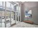 Park Devereux bright lobby with marble tile floors, modern art, sitting bench, and glass entrance at 200 S Dawson St # 303, Raleigh, NC 27601