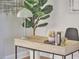 Close-up of office desk featuring décor items, books, and art at 200 S Dawson St # 303, Raleigh, NC 27601