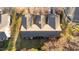 An aerial view of the townhouse complex showcases its spacious back patios at 209 Intern Way, Durham, NC 27713