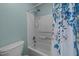 Cozy bathroom features a shower-tub combo with a blue and white floral shower curtain at 209 Intern Way, Durham, NC 27713