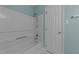 This bathroom has a shower-tub combination and a white door at 209 Intern Way, Durham, NC 27713