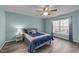 Relaxing bedroom boasts a window, ceiling fan, and a cozy blue bed at 209 Intern Way, Durham, NC 27713