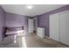 Comfortable bedroom featuring soft purple walls, closet, and natural light at 209 Intern Way, Durham, NC 27713