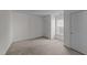 This bedroom has neutral carpet, white walls, and a large window at 209 Intern Way, Durham, NC 27713