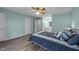 Comfortable bedroom featuring soft blue walls, a ceiling fan, and plush bedding at 209 Intern Way, Durham, NC 27713