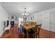 Bright dining area featuring a chandelier and wood flooring, adjacent to living area at 209 Intern Way, Durham, NC 27713