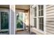 Inviting front porch with decorative door, accent lighting, and a welcoming welcome mat at 209 Intern Way, Durham, NC 27713