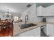 Open kitchen with a granite-topped island overlooking the living and dining area at 209 Intern Way, Durham, NC 27713