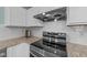 Close up of a kitchen featuring granite countertops, stainless steel appliances, and white subway tile backsplash at 209 Intern Way, Durham, NC 27713