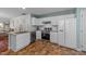 Bright kitchen featuring white cabinets, stainless steel appliances, and neutral countertops at 209 Intern Way, Durham, NC 27713