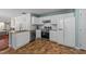 Well-lit kitchen with white cabinets, stainless steel appliances, and granite countertops at 209 Intern Way, Durham, NC 27713