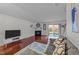 Cozy living room featuring a fireplace, sliding glass doors, and wood flooring at 209 Intern Way, Durham, NC 27713