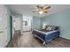 Bright main bedroom with ensuite bathroom featuring a ceiling fan and cozy bedding at 209 Intern Way, Durham, NC 27713