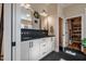 Elegant bathroom featuring dual sinks, modern fixtures, and a doorway leading to a walk-in closet at 2109 Meadowcreek Dr, Durham, NC 27705